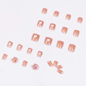 Nude pink press-on nails set with white french tips and 3D butterfly bow accents