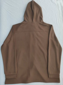 Rear view of slim fit hooded windbreaker jacket in brown displayed on white checkered fabric