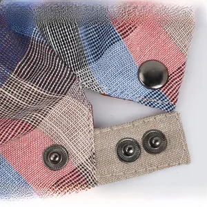 Detail of adjustable metal snaps on a colorful plaid cotton linen flat cap with vintage finish