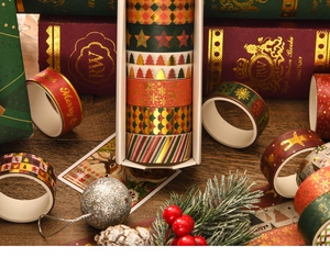 Close-up of Christmas washi tape set featuring gold foil patterns and festive textures