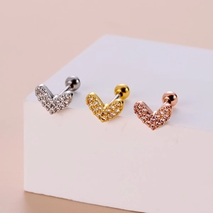 Three heart-shaped stud earrings in silver gold and rose gold with zircon on a white cube