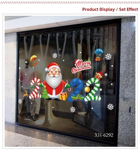 Detailed view of Merry Christmas window decals with Santa Claus and snowflake patterns