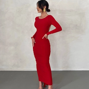 Close-up of elegant backless detail on a slim-fit red maxi dress with long sleeves