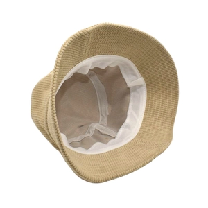 Detail view of khaki corduroy bucket hat showing soft texture and inner lining