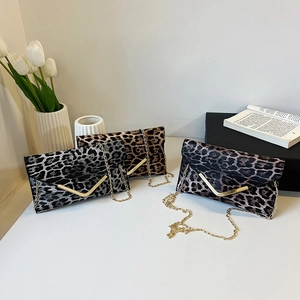 Three leopard print envelope clutch bags with gold V-trim and delicate chain straps