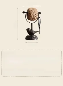 Detail showing vintage cast iron bird twine holder with 22cm height and 14cm width size markers