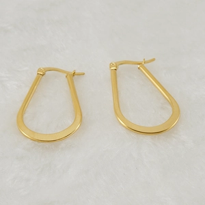 Minimalist 18K gold plated stainless steel teardrop hoop earrings on soft white fabric