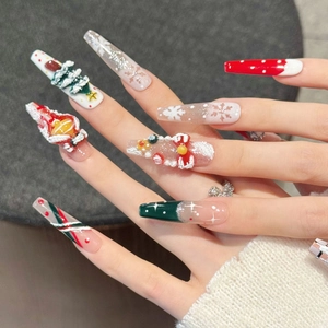 3D Santa Christmas press-on nails with red bows and snowflake designs in coffin shape
