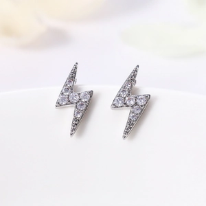 Macro view of lightning-shaped stud earrings with micro-pave white cubic zirconia