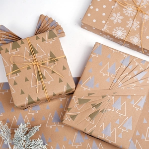 Brown kraft Christmas wrapping paper roll with festive snowflake and tree patterns
