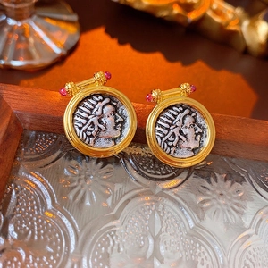 Vintage gold hoop earrings with portrait coin relief and small pink gemstone accent
