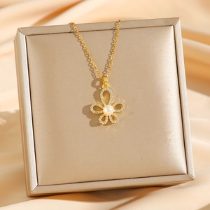 Elegant gold titanium necklace featuring a diamond-encrusted five-petal flower with pearl