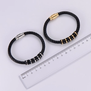 Detail view of woven leather bracelets with magnetic clasps and length scale measurement
