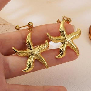 Golden starfish dangle earrings for women featuring a beach vacation style design