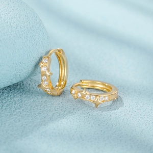 Macro shot of gold-plated S925 sterling silver hoop earrings with sparkling star zircon stones