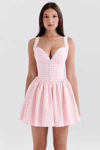 Detail of pink plaid mini dress featuring white lace trim and ruffled hem design