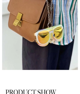 Detail view of a laser-style eyeglass shaped pouch with a silver metal chain on a bag