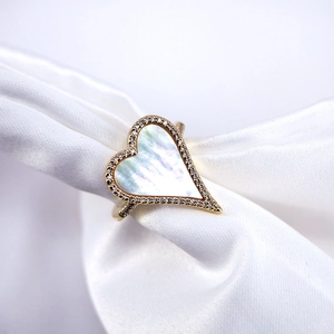 Close-up of heart-shaped ring with mother of pearl inlay and micro-set cubic zirconia stones