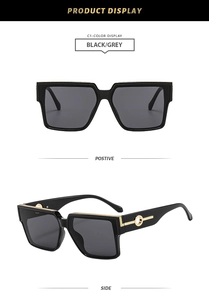 Detail of square black sunglasses showing golden geometric metal accents on temples