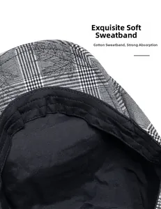 Detail view of cotton sweatband inside black and white plaid ivy cap for comfort