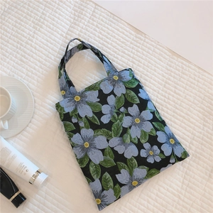 Close-up of vintage floral jacquard fabric on the black cotton tote bag with handles
