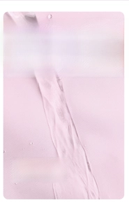 Close-up of pink water-repellent fabric with moisture beads on durable backpack material