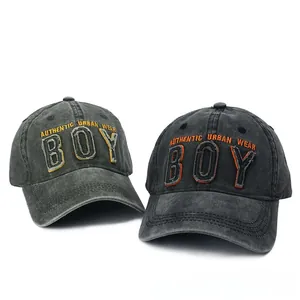 Close-up of washed cotton baseball caps with vintage BOY embroidered patches