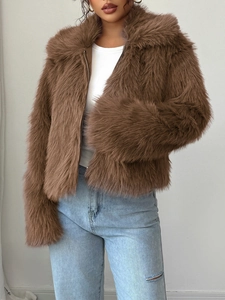 Detail of a brown faux fur jacket showing plush texture and smooth zipper closure