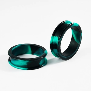 Detail of soft silicone ear tunnels with black and turquoise marble pattern textures
