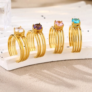 Detail of four-layered gold-plated stainless steel rings with colorful zircon stones