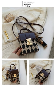 Detail of coffee brown argyle crossbody bag with gold buckle and cute bear charm