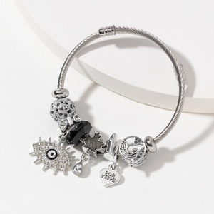 Silver stainless steel charm bracelet with evil eye, leaf, and For Keeps heart pendant