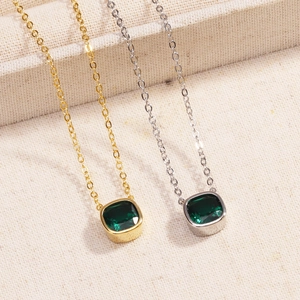Detailed comparison of gold and silver necklaces with square emerald green pendants