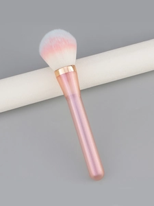 Macro detail of the gradient pink bristles and rose gold ferrule on this powder brush