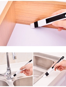 Detail of slim crevice brush cleaning window grooves and stainless steel faucet edges