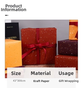 Detail of gold foil flecks on kraft paper gift wrap rolls in red and orange tones