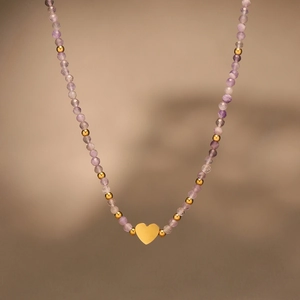 Handmade necklace with purple natural stones, gold beads and a central heart pendant
