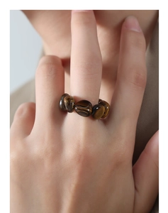 Macro shot of tiger eye stone beads ring showing natural textures and cat eye effect