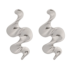 Macro shot of silver-colored spiral wave earrings in high-polished stainless steel