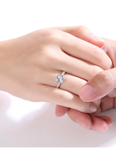Close-up of elegant S925 sterling silver ring with round moissanite on female hand