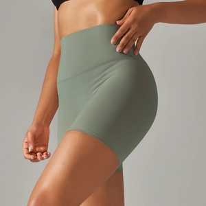 Close-up of high-waisted sage green yoga shorts with double-sided brushed matte fabric