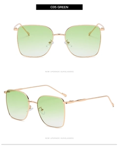 Detail view of square sunglasses featuring green gradient lenses and gold metal frames
