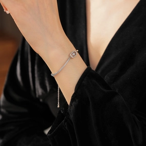 Detail of 18k gold plated chain bracelet with dancing cubic zirconia center stone