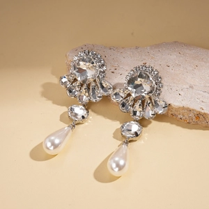 Baroque silver earrings with crystal flowers and white teardrop pearls on a stone base