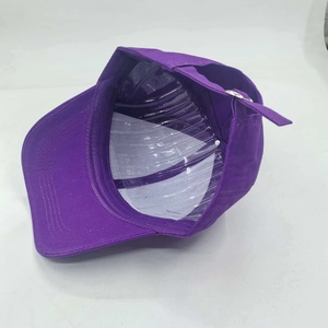 Detailed interior of purple baseball cap showing adjustable metal buckle and smooth fabric