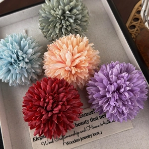 Detailed view of colorful fabric pompon chrysanthemum flower heads for hair accessories