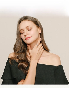 Detail shot of vintage 925 sterling silver leaf ring worn by a model on a warm background