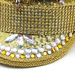 Detailed close-up of golden sequins and colorful rhinestones on a festive party hat