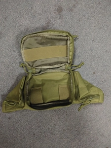 Detailed interior of tactical waist bag showing elastic straps and velcro storage