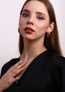 Close-up of minimalist 18K gold plated woven chain necklace with mini zircon pendant